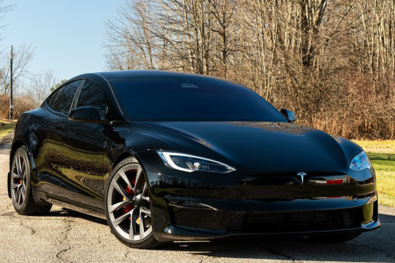 A Tesla Model S parked on the side of the road, showcasing its sleek design and modern features.